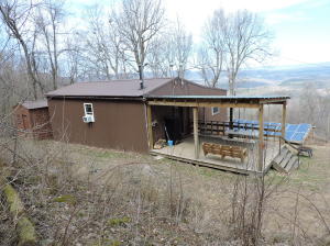 Looking for an off the grid cabin near the Buffalo River National Park and the National Forest? Here it is! A two bedroom, one bath cabin, fully furnished on 16.8 ac m/l. Water catch system with approximately 2000 gal capacity in tanks. A high end solar system with a 4000w and 1500w power inverters and 2 gas generators. The view from the covered deck and cabin is absolutely one of the best in the Ozark Mountains. Cabin has a wood stove, 2 propane wall units and 2 window a/c. End of the road privacy yet only 6 mi to Jasper. Access by 4 wheel drive only. You will not believe this view!