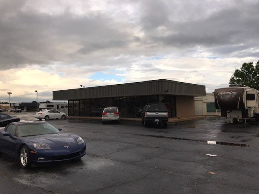 This commercial property is a corner lot on Main St and consists of 3+/- acres and 2 buildings. It is currently being used as a Used Car Dealership. The land and buildings are for sale, not the business.  The Office building is 1920 sqft with multiple offices.  The Shop/Warehouse is 6400 sqft.  This property has 2 separate curb cuts on Main St, 3 cuts on Verona and 3 on 2nd St. Future plans has the Weir Rd extension on ramp right beside the property. Additional parcel has address of 2203 E 2nd St.