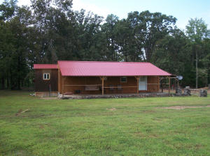 Hey hunters! This is what you've been waiting for! Your own get-a-way with 27 scenic acres North of Dover that adjoins National Forest on 2 sides and it is also across the street from National Forest. The cabin has all the conveniences of home with a nice kitchen, relaxing front porch, and a sturdy metal roof. Call today because with hunting season coming up, this won't last!