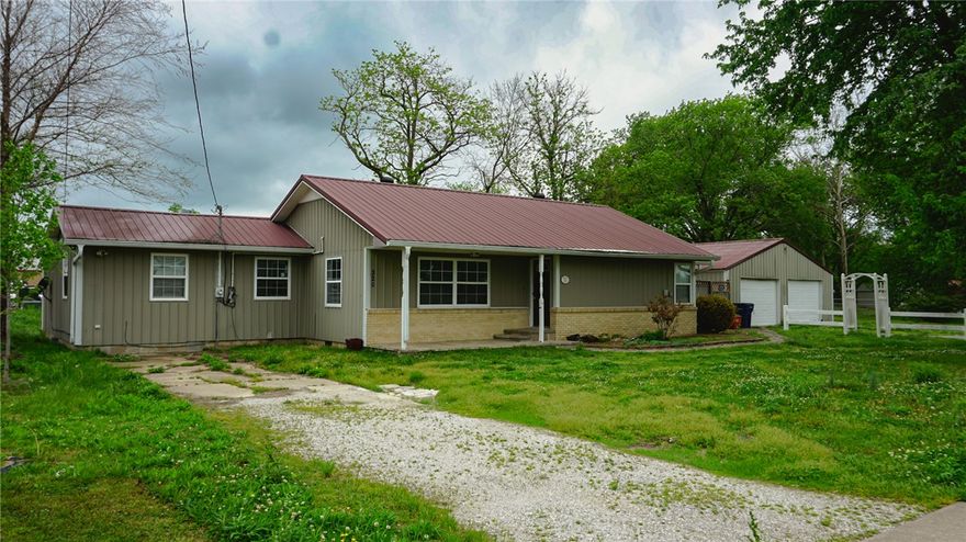 Located less than half a mile from 412, this spacious home is ready to be made into your own personal Country Club. It features beautiful hardwood floors, walk in closets, a large detached garage and a spacious .40 acre lot. The 28x30SqFt detached garage is perfect for a personal workshop or entertaining guests with outdoor access. And it's centrally located off of E Main St, just 7 minutes from the Oklahoma border and 20 from Springdale.