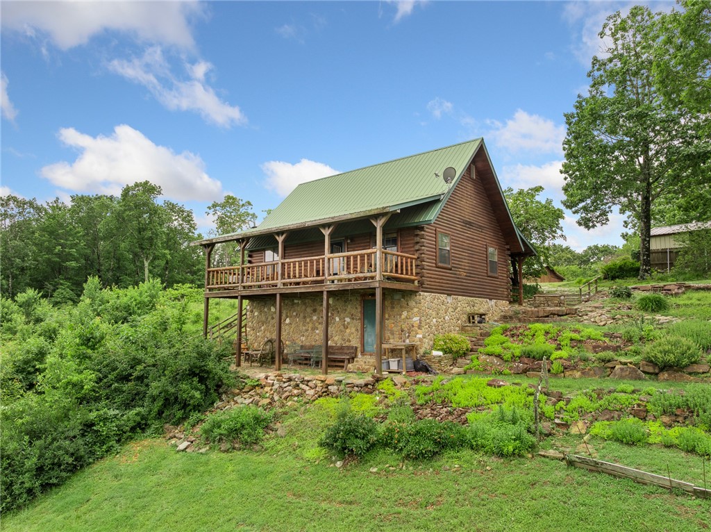 Step into timeless charm and rustic elegance with this authentic Ozark-style cedar log home perched above the stunning Arkansas Grand Canyon—offering some of the most spectacular views in the entire Ozark region. Located just outside the charming town of Jasper on the highly sought-after Scenic Highway 7, this one-of-a-kind property captures the spirit of the mountains with modern comfort and unbeatable natural beauty. Offering two bedrooms, 1 1/2 bathrooms, and fully furnished with custom log furniture to match the cabin feel of the home. This property would make a great full time residence or investment property / rental in the area. All contents and furniture convey with sale.