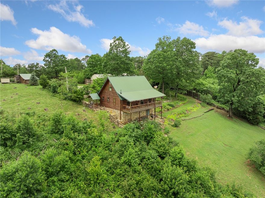 Step into timeless charm and rustic elegance with this authentic Ozark-style cedar log home perched above the stunning Arkansas Grand Canyon—offering some of the most spectacular views in the entire Ozark region. Located just outside the charming town of Jasper on the highly sought-after Scenic Highway 7, this one-of-a-kind property captures the spirit of the mountains with modern comfort and unbeatable natural beauty. Offering two bedrooms, 1 1/2 bathrooms, and fully furnished with custom log furniture to match the cabin feel of the home. This property would make a great full time residence or investment property / rental in the area. All contents and furniture convey with sale.