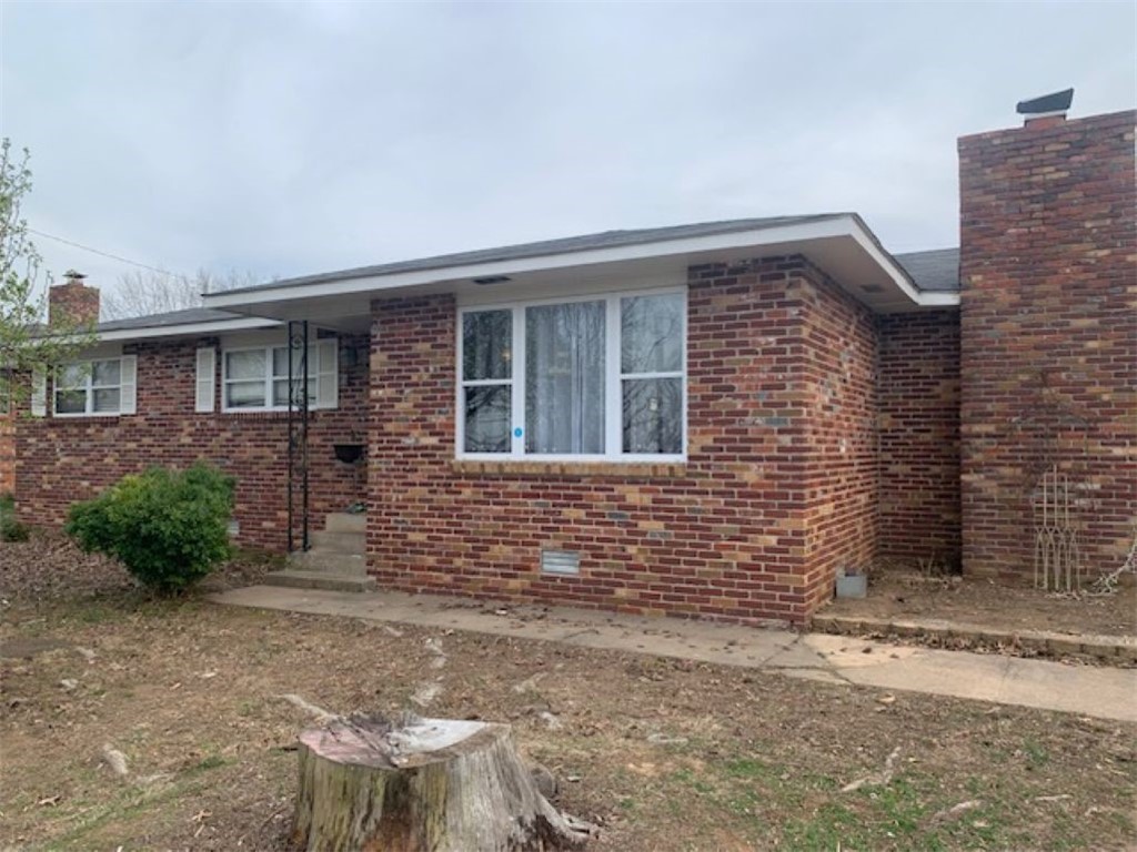 All brick, large fenced lot, near Rogers High School. 2 living areas large wood burning fireplace.