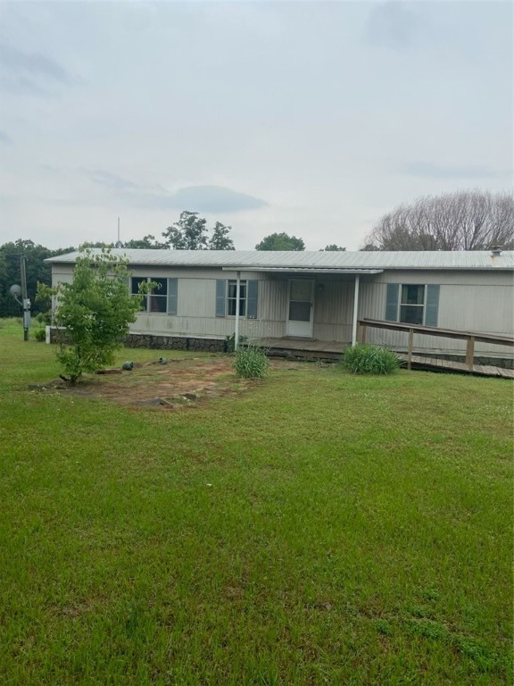 This is a 3-bedroom, 2-bath mobile home featuring a 40x12 sunroom at the rear. It is situated on 10 acres of level pasture land, complete with a pond and fully fenced pastures, including a small loafing shed. The property also has a detached metal workshop. The washer, dryer, and refrigerator are included with the sale.