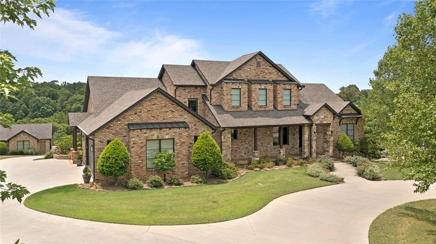 An extraordinary property tucked away in the quiet enclave, Estates at Dogwood Canyon & perfectly nestled on 2 wooded acres. The quality of construction & use of the finest materials are evident throughout the home. Enter through the solid wood arched front door, & foyer is flanked by the study and dining room. The great room has a beautiful vaulted ceiling with open wood beams, hand-laid stone fireplace & gorgeous property views. The open chef's kitchen boasts custom cabinetry, professional stainless steel appliances, granite countertops, hammered copper farmhouse sink, wine fridge & center island with copper prep sink. Expansive primary suite & guest room w/ensuite bath both on main level.  2nd level boasts 2 bedrooms w/jack & jill bath & spacious bonus area. The covered veranda is the heart of the home where countless memories are made, enjoying alfresco dining, fireside chats, or simply lounging while taking in the peaceful wooded views. New window treatments, designer lighting, carpet & fresh paint throughout!