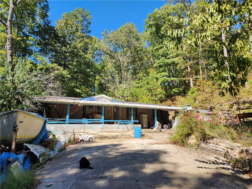 Discover peaceful rural living in this spacious 4-bedroom, 2-bath manufactured home set on over half an acre near Beaver Lake and the national forest. This home features a split floor plan, an inviting eat-in kitchen, and comfortable living spaces with plenty of natural light. Walk-in shower and whirlpool tub for added relaxation. Enjoy the outdoors on the covered porch or deck surrounded by wooded views. Property includes a well house, private septic, and well water. With community lake access nearby and plenty of space for outdoor activities, this property offers an ideal blend of privacy, nature, and everyday convenience.