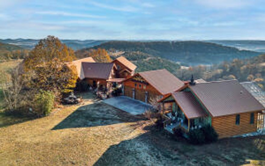 Between Harrison, AR and Branson, MO this luxury property will be your serene escape from the bustle of the world. Custom craftsmanship describes this property. Gorgeous hand carved double doors welcome you inside where beautiful vaulted ceilings, a stone fireplace and a wall of windows over look the soothing view of the Ozark Mountains. Two exquisite master suites with all expected amenities. One has floor to ceiling windows taking in the 180 degree view. Custom tile work in all showers.  Guest cottage offers many opportunities for visitors, caretakers, or multi-generational families. 3 Kitchens plus an outdoor kitchen and dining space, swim spa, generator, shop building, green house,  Reach out to your agent to obtain access to the listing of the amenities too numerous to detail here.