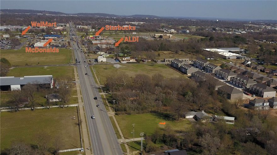 Investerment and Develop Oppourtunity This 3.02 commercial zoned parcelm sits right in a rapid growing area of Springdale. Commercial Road frontage with strong traffic counts and exposurewith proximity to I-49 is a fantastic space and location for retail, strip mall, apartments, gas stations, warehouse space, office space, and more! On site stands a 3240 Square Ft Home on site, and Shop Building -ideal for office conversion or investment, This property is only approx .4 miles from McDonalds, Aldis, Walmart Super Center, Starbucks, and Mercy Emergency Hospital, Do Not miss out on this oppourtunity to purchase a great tract of commercial zoned land mostly cleared and ready for you to start your investment.