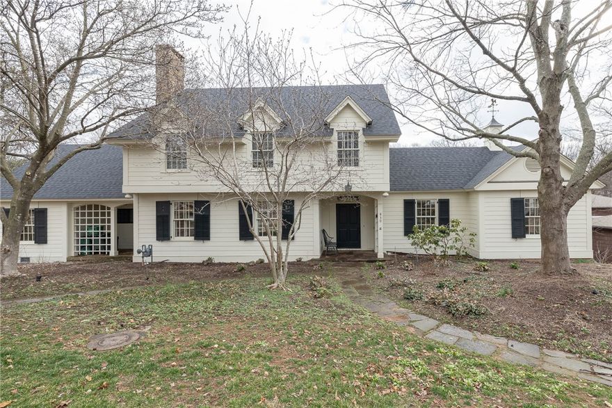 Incomparable historic home built in 1931 with wonderful amenities! Located just half a block from Wilson Park & the Razorback Greenway, and half a mile from the U of A & downtown, this home blends timeless charm with modern convenience. Filled with character & original details, it features hardwood floors, three levels, & three fireplaces. The spacious layout includes a living room, formal dining room, den, office, & 4-5 bedrooms with 3.5 baths. The updated kitchen shines with Carrara marble, a gas cooktop, wine cooler, two porcelain sinks, refrigerator, dishwasher, microwave, & a large island bar. Step outside to a flagstone patio & courtyard with a tranquil water feature. The guest apartment is a standout, offering its own kitchen, bedroom, bath, living & dining room, vaulted ceiling, fireplace, laundry, & a great deck. Don’t miss this rare opportunity to own a piece of Fayetteville’s history in a truly iconic location!