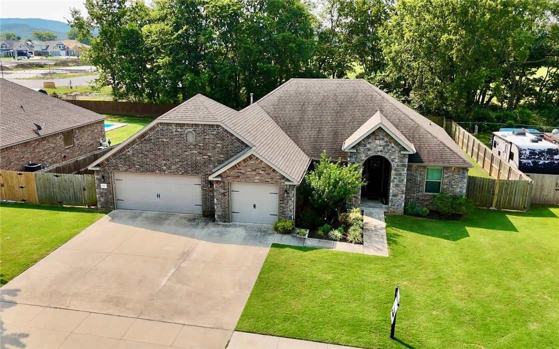 This beautifully maintained one-level 3-bedroom, 2-bath home stands out with thoughtful upgrades and extra space both inside and out. Nestled on a .32-acre lot with mature trees in the backyard, it offers privacy, and room to garden—with a raised garden bed, compost bin, and French drain system already in place.
The open-concept design showcases granite countertops, wood floors, stainless steel appliances, and a spacious kitchen island—ideal for cooking or entertaining—along with a generous pantry. Just off the living room, you’ll find a flexible space perfect for a home office. The oversized primary suite offers a massive walk-in closet with a rare and convenient walk-through to the laundry room—a rare and practical touch.
Additional highlights include a 3-car garage, covered back patio, and a large, level yard ideal for outdoor enjoyment. Located just minutes from Prairie Grove schools, the aquatic park, and public library, this home combines modern comfort with small-town charm and community appeal.