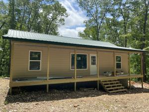 BRAND NEW cabin in the woods. The cabin features 960 square feet on 7.35 Acres!! With 2 BR, 2 BA, large windows and covered porch to enjoy the Ozark mountain views! The land is mostly wooded and private and close to the Buffalo National River Park!