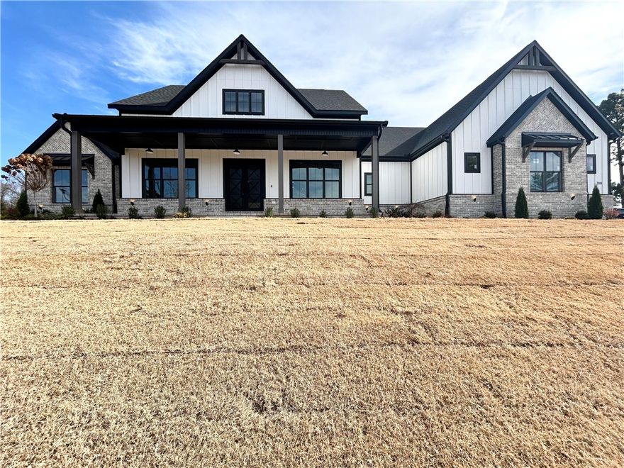 New construction estate in Healing Springs! This stunning home sits on a flat 1-acre lot, offering serene wooded views and privacy. Featuring a large 3-car garage with epoxy floors, this residence boasts 5 bedrooms plus a formal dining and bonus room. Natural light floods the open living and kitchen areas, creating an inviting atmosphere for gatherings or relaxation. The kitchen is a chef's dream, featuring floor-to-ceiling cabinets, double oven, 36'' 6 burner gas cooktop, built-in refrigerator, and an oversized pantry. The primary suite includes a fireplace, wood ceiling & beams, double vanity, soaking tub, and an oversized walk-in custom shower. Enjoy entertaining on the huge covered patio, complete with a ½ bath, fireplace, grill, and fridge—ideal for outdoor gatherings. Plenty of space for an in-ground pool!  Custom finishes and built-ins throughout! Bentonville schools. Schedule your showing today.