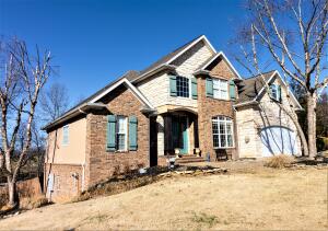 Custom home in the Estates at Harrison Country Club. This great home features 18' ceilings, beautiful kitchen with a hearth room with fireplace, granite countertops, and wood floors. Living room, dining room, and large master suite plus half bath for guests on main level. Lower level has large den w/kitchenette, large bedroom with walk in closet and full bath attached, perfect for teens or guests. Lower level also has two additional rooms which could be offices, storage, etc.. Upstairs, there's 2 bedrooms, full bath and bonus room. This home has lots of storage,large deck and fully fenced back yard. Above ground pool and concrete pad for basketball court! $5,000. flooring allowance, sellers w/need delayed occupancy. Sq Ftg approximate.