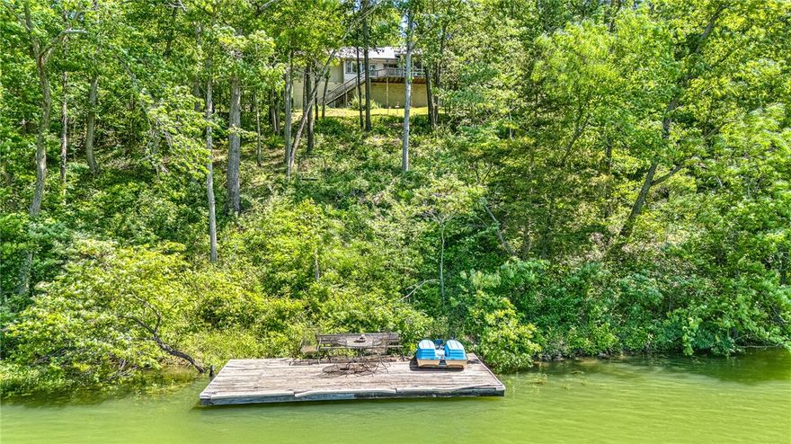 Welcome to your lakefront retreat on Bella Vista’s most exciting lake! Tucked into a quiet cul-de-sac, this lakefront property on over an acre of land sits just around the corner from the Marina and Lakepoint Restaurant. Relax and take in the scenic views of the lake and wooded backyard from the screened-in porch. Inside, you'll find thoughtful details throughout, including a gorgeous rock fireplace in the living room, built-in desk and eat in area in the kitchen, and a wet bar in the dining area. This flexible floor plan has a versatile bonus/flex room off the kitchen, ideal for a home office, hobby space, playroom or anything you need. The spacious primary suite features double closets and a bathroom with a whirlpool tub for ultimate relaxation. Whether you’re enjoying the lake, entertaining guests, or simply soaking in the natural beauty, this home delivers the best of Bella Vista lakefront living.