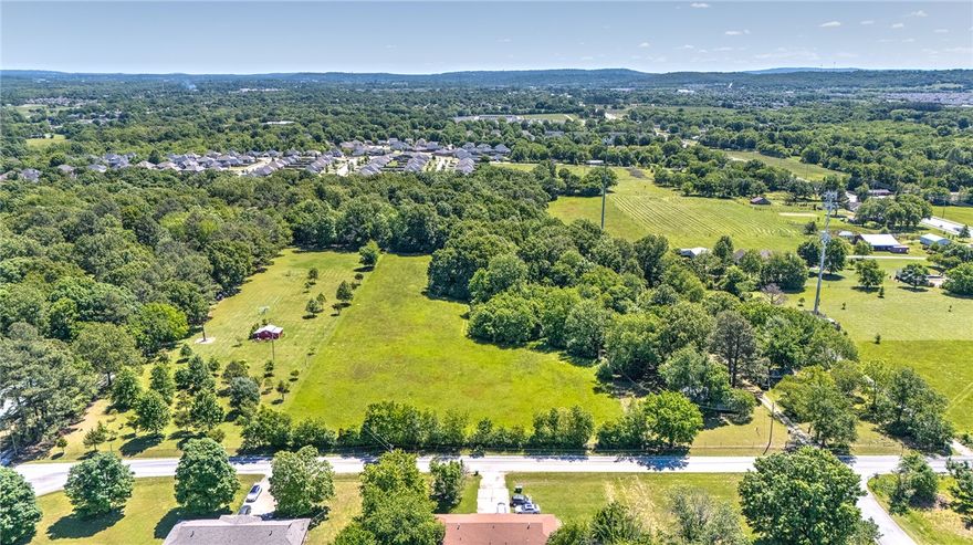 Just outside Fayetteville, Arkansas, this remarkable 10-acre property combines privacy, natural beauty, and convenience—only ten minutes from the University of Arkansas. A rare mix of open acreage and mature woods provides multiple build sites to suit your vision, from a custom estate home to a family compound or small development.

The buildable areas offer cleared and level terrain, while the gently rolling wooded section at the back features towering hardwoods that create a serene, secluded backdrop and space for recreation. With utilities available at the street and abundant wildlife, the setting feels beautifully remote yet remains close to all the amenities and energy of Fayetteville.

Experience the best of both worlds—peaceful countryside living on the edge of the city. Call today for your private tour and discover all that this exceptional property has to offer.