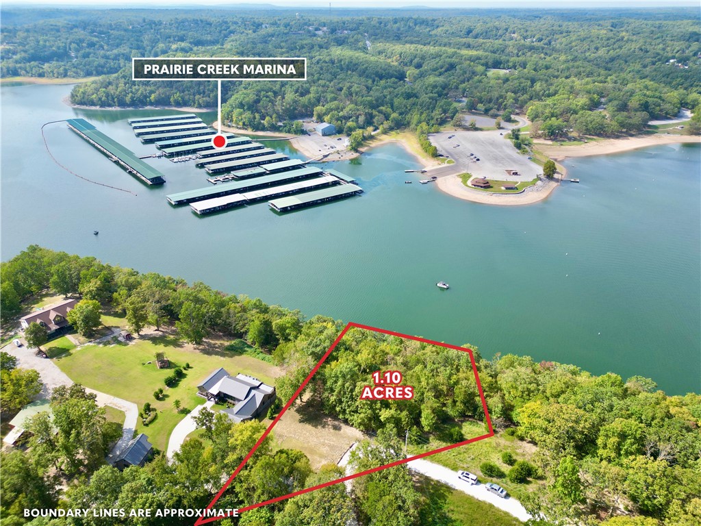 2 boat slips on Beaver Lake across from Prairie Creek Marina!! Private, no wake cove - Discover the perfect canvas for your dream home on this expansive 1-acre lot, nestled in the serene community of Rogers, AR. Situated on picturesque Beaver Lake, this property offers a rare combination of tranquility & convenience, with no restrictions to limit your vision. Enjoy unparalleled access to the water with 2 private boat slips, making it effortless to embrace the lake lifestyle. Located off Kindred Hollow Road, this property is ideally positioned right across from Prairie Creek Marina in a no wake zone, ensuring that all your boating needs are just a stone's throw away. Imagine waking up to stunning lake views, enjoying peaceful evenings by the water, and creating lasting memories in your custom-built sanctuary. Seize this unique opportunity to design & build the home youāve always dreamed of in a location that offers both natural beauty & modern convenience. This prime piece of Beaver Lake real estate wonāt last long!