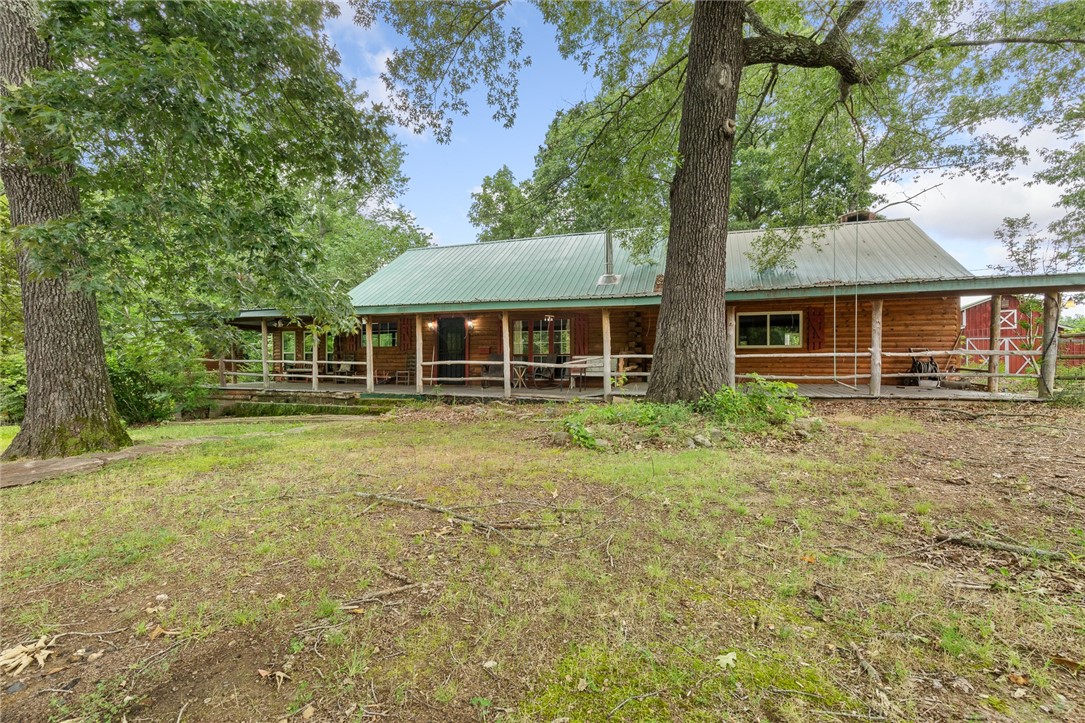 This beautiful 10-acre property offers a spacious 5-bedroom cabin featuring a large living room and dining area, perfect for entertaining. A second cabin, currently set up as a bunkhouse with 5 beds, provides extra space for guests or rental potential. Enjoy the outdoors with a large red barn, covered RV parking, and a stunning back deck that connects both cabins, centered around a cozy gazebo. The property also includes an outdoor fireplace, fenced acreage, mature timber, and a wide, cleared yard ideal for recreation or relaxation. Massive covered front and back porches complete this peaceful retreat, offering the perfect blend of comfort, space, and nature. And only 1.5 miles to Hasty and 5 miles to Carver.