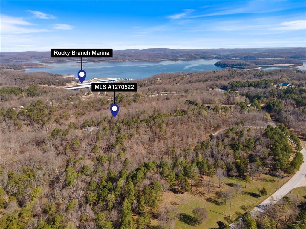 Embrace the allure of lake living on this exceptional 1.67-acre property near the enchanting Rocky Branch Marina & Campground, nestled along the shores of Beaver Lake. Spanning two lots, this picturesque acreage boasts serene wooded slopes, offering the perfect canvas for your dream lake home. Enjoy convenient access to hiking and biking trails, as well as the nearby Hobbs State Park. Escape the hustle and bustle of city life while being just a short 15-minute drive from the vibrant Downtown Rogers. Don't miss this chance to create your own lakeside sanctuary in the heart of beautiful Northwest Arkansas!