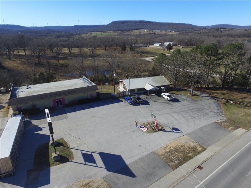 Two large commercial buildings, 15,000 total gross sq.ft. with both levels.  5,100 sq.ft. retail with large walk in coolers, 5,100 sq.ft. basement storage with drive in and walk in door, freight elevator, office that overlooks retail space, second building 2,400 sq.ft. retail space with apartment in basement and storage space. Paved parking lot and total of 1.67 acres.  With great Hwy 62 frontage there are lots of possibilities for multiple businesses on this location.