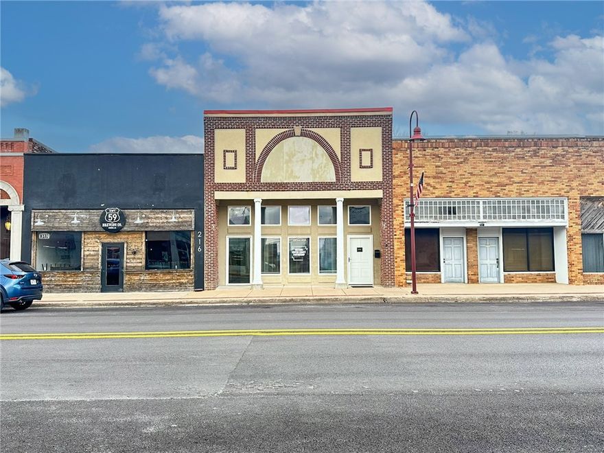 This commercial property offers a highly visible location along E Main Street, one of Gentry’s primary commercial corridors, placing it directly in the heart of downtown activity and daily local traffic. Its central setting provides excellent exposure within the community, making it well suited for a variety of uses including retail, office, professional services, salon, or specialty businesses. The building includes a convenient drive-in roll-up door and a small second-floor apartment, adding flexible potential for owner-users, supplemental income, or creative business configurations. Supported by a strong small-town customer base and limited nearby competition for many service-oriented tenants, the property presents an outstanding opportunity to establish a long-term presence in a growing Northwest Arkansas community.