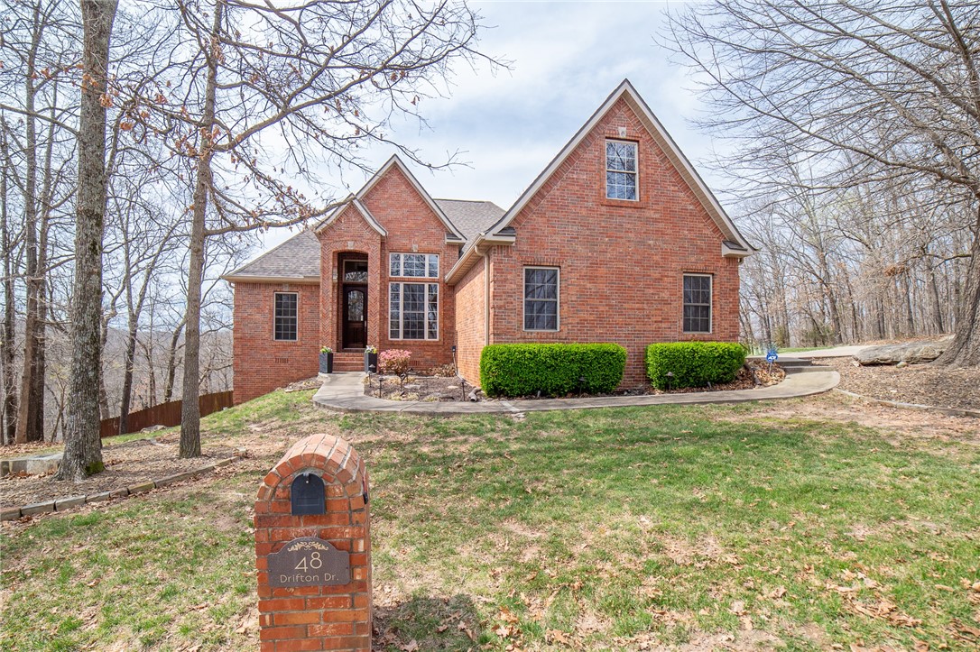 Enjoy 180 degrees of picturesque views year around while sitting on your west-facing back deck. This home truly has it all from the gorgeous hardwood floors inside to the gorgeous hardwood trees outside. Split floor plan w/three separate living spaces. The first living space is on the main level, featuring high ceilings yet cozy w/windows overlooking the back deck. The second space is the bonus room upstairs off the kitchen, and the 3rd is in the basement and equipped with full a kitchen. Have the watch party for the big game downstairs and never have to go upstairs for snacks. The main level has 3 bedrooms and 2 full bathrooms. Fourth bedroom & 3rd full bathrm are located in the basement. The primary suite is located on the main level and has 2 vanities w/sinks, tiled walk-in shower, jetted tub, and 2 closets. Custom built-ins in bonus room and front bedroom. Roof replaced in 2020, HVAC (big unit) is 5 years old, along with the microwave and dishwasher. Kitchen & basement fridge, washer/dryer convey. HomeWarranty