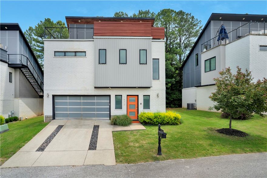 A striking architectural residence where sophisticated design meets elevated living. This contemporary 3 BR 2.5 BA home was thoughtfully crafted for refined entertaining, highlighted by an extraordinary patio with a raised glass garage door overlooking the living space below—an unmistakable statement of modern luxury. The open concept interior is flooded w/natural light showcasing soaring wood ceilings, expansive windows, hardwood floors, industrial inspired kitchen w/quartz countertops. A dramatic balcony w/retractable glass door opens to private rooftop terrace & LR below & breathtaking panoramic views of Fayetteville. MBR serves as a serene retreat, accentuated by designer feature wall and a spa inspired bath w/an oversized walk-in shower. Other BRs offer generous proportions and refined comfort. Ideally located just minutes from the downtown square and entertainment district, this one-of-a-kind property delivers exceptional style, coveted amenities, and outstanding potential as a luxury investment property.