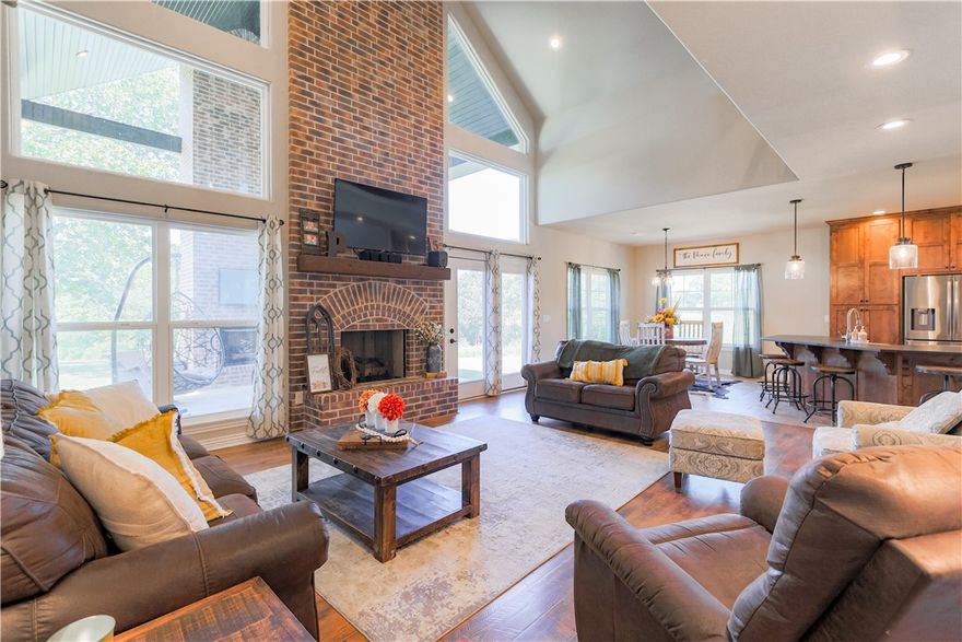 Priced to sell and just minutes from everything there is to love about Northwest Arkansas, this 5 acre setting could not be more convenient or peaceful! Perfect all brick home comes with a 1,200 square foot shop (electric, plumbing, and HVAC in place) providing an opportunity to live your turn key country dream. The easy flowing floor plan, vaulted ceilings and abundant natural light from the window wall provide an inviting and elegant atmosphere for you to come home to every day. The spacious primary suite has private access to the covered back porch that features an outdoor fireplace and is perfect for enjoying the serenity of the Northwest Arkansas countryside or for entertaining friends and family if you so choose. The kitchen is open into the family room and features beautiful floor to ceiling cabinetry, a full pantry, an appliance cabinet, and plenty of counter space. Large bedrooms, a bonus room, 3 full baths, and a large laundry room make this the perfect family home available just in time for the holidays!