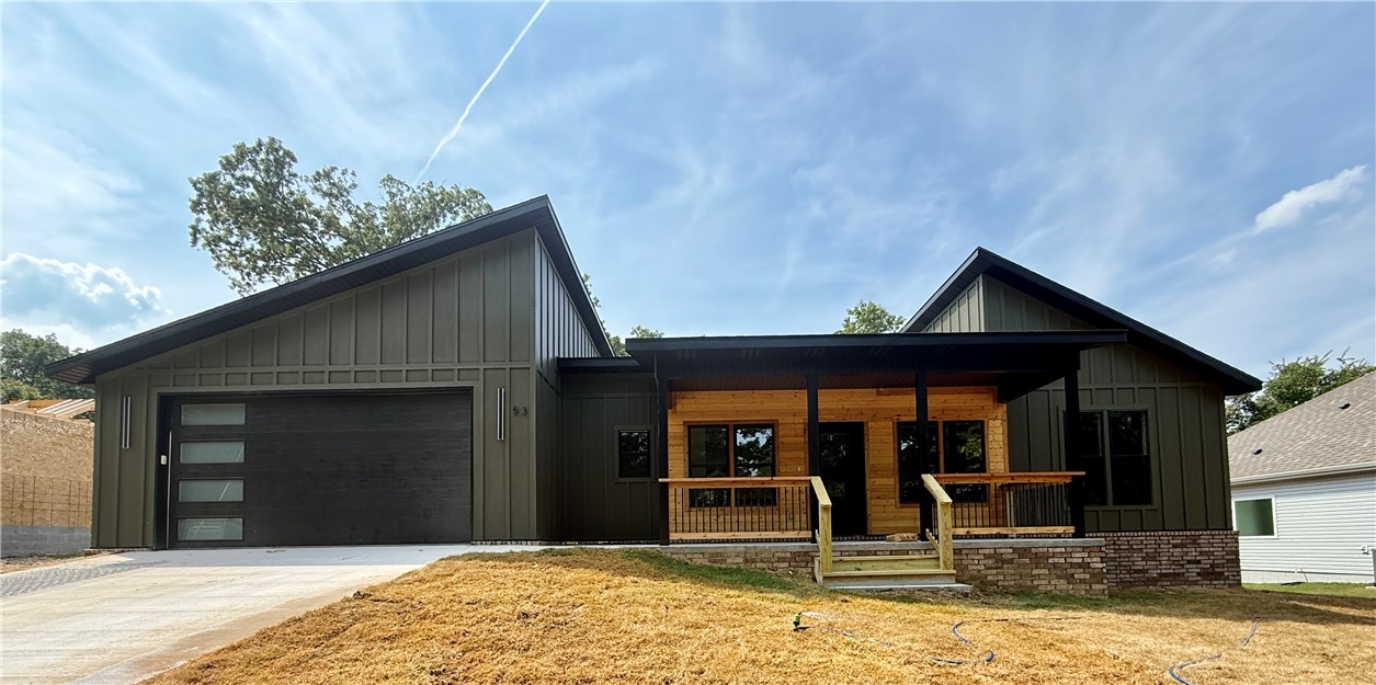 Beautiful new construction featuring a modern design with over 1,800 sq. ft. on a single level. This 3-bedroom, 2-bath split floor plan includes walk-in closets, wood flooring in the main living areas, and tile in the wet spaces. The spacious kitchen boasts quartz countertops throughout and opens to generous living and dining areas. The utility room offers excellent storage and convenience with a built-in sink.
The primary suite features a luxurious bath with a soaker tub, walk-in shower, and dual vanities. Enjoy outdoor living with a charming covered front porch and a large covered back patio overlooking the flat yard. Conveniently located near Summit School and Pinion Creek mountain bike trails, in the desirable Bentonville School District.