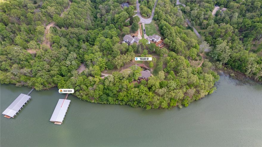 Immaculate Lakefront Home with Boat Slip! Completely renovated with great attention to detail, this 4-bedroom home offers multiple living spaces, stunning landscape & large outdoor living spaces. Formal Dining and Office off entry. Bright & open living room flows into spacious eat in kitchen boasting wine bar, gas cooktop, quartz counters & more! Primary suite is a true retreat with access to deck & lake views & luxurious walk-in shower in attached bath. Guest bed and bath on main level. Lower level has large second living area w/fireplace and kitchenette. A large covered patio provides extra outdoor living space. 2 guest bedrooms and guest bathroom on lower level along with basement workshop space. Your 2.89 Acre lot features 739 ft of lake frontage, community dock is easily accessible for your personal slip which has boat lift. Close to Downtown Rogers, Parks & Trails. Upgrades incl. Roof in ’24, Windows ‘22, HVAC ’14, HW Heater’20, Floors ‘21, Appliances 21’, Counters 21’ & more. Contact agent for full details.