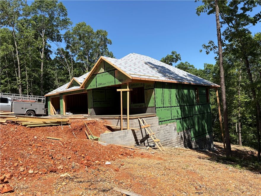 This new construction home has three bedrooms each with an on suite bathroom. Three car garage with a nearly 30' deep boat or RV stall, wifi enabled garage door openers & a EV charger in garage. Bentonville schools, Tunnel Vision bike trail at the back of the lot, built on two lots (.68 acres), knotty alder wood accents, barn door, modern style electric fireplace. One bedroom could easily be used as an office. Recreation or theatre room on the lower level, two porches - one covered roof & screened on the upper. The home is located close to Bella Vista Park/Lake, bike & hiking, plenty of golf courses & lakes to choose from, tennis courts, pools, fitness centers and more.
Estimated completion date 7-31-25