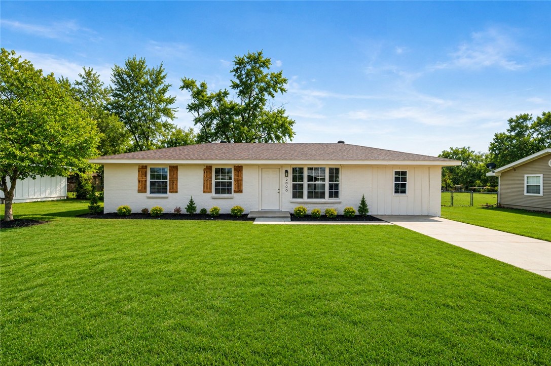 White brick exterior featuring brown wood-look shu