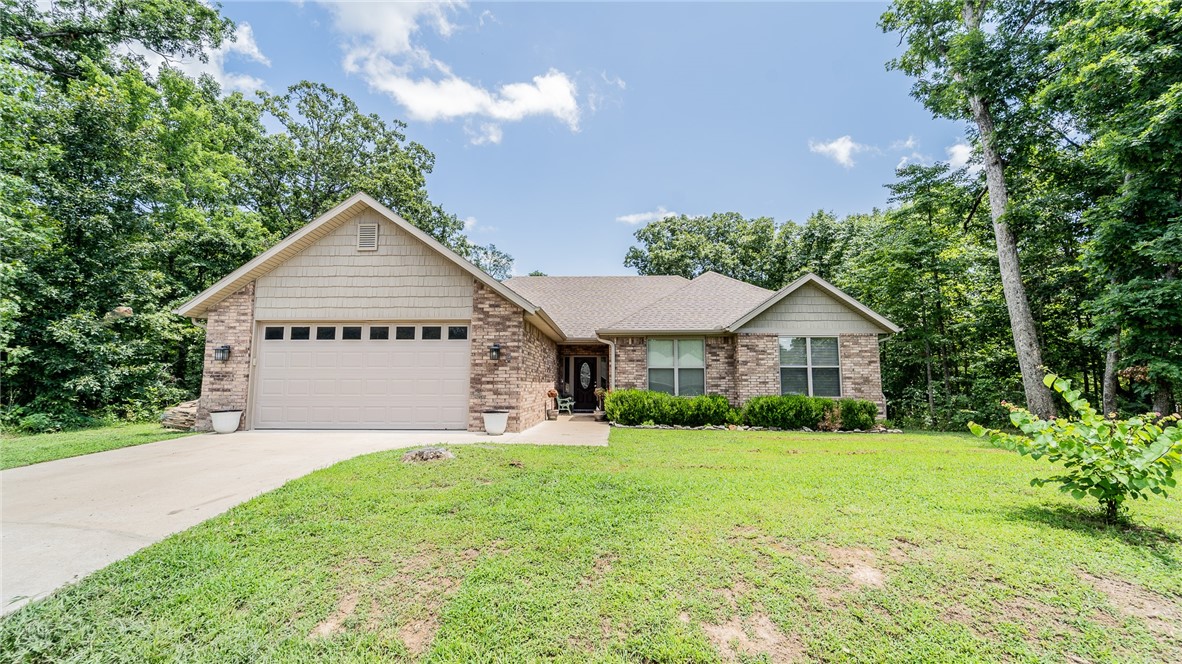 Welcome to this well maintained custom built home that sits minutes from everything in Bella Vista. This 3 bedroom, 2 bath, 1878 sq ft home is move in ready. Walk into the open floor plan with ceramic wood tile flooring, vaulted ceilings and beautiful back porch. The main suite features a large soaking tub and walk in closet. This home has many custom features with a fully landscaped yard and level front yard. Sitting on the back deck you are surrounded by large mature trees. With no neighbors on the side or back you feel like you are in the deep woods. A new stone patio is being completed in the backyard. This home has it all.