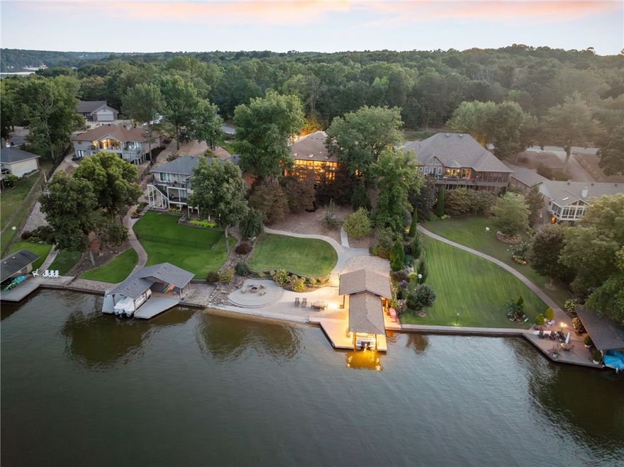 Nestled on the shores of Lake Loch Lomond, this remodeled lakefront home offers the perfect blend of luxury and comfort. Step inside to find a spacious, open-concept design featuring a large kitchen with sleek quartz countertops, newer appliances, and a seamless flow into the living room, all with stunning views of the lake. The main-floor primary suite is a true retreat offering peaceful lake views.  The finished basement provides a second living area, two additional bedrooms, and a cozy bunk room, making it ideal for guests or family.  Outside, you'll find an entertainer's dream with a private boat dock, a fire pit, and a relaxing lounge area. The outdoor kitchen comes complete with a built-in gas grill, while the beautifully landscaped yard includes fruit trees and a paved walking and cart path that leads directly to the lake.  New HVAC system, water heater, and a new roof, ensures that everything is in top condition. This home truly offers everything you could dream of in a lakefront retreat.