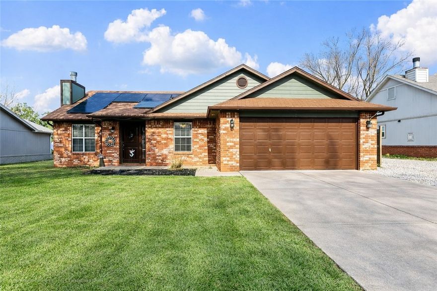 Updated home in a prime Rogers location! Backing up to Reagan Elementary, this charming, all brick property offers convenience and comfort with easy access to schools, restaurants, and I-49. Inside, you’ll find vaulted ceilings, gas fireplace, open living room to dining room and stylish new flooring throughout the home. The kitchen features an electric range (replaced in 2016), while all bathrooms have been upgraded with new faucets and granite countertops. Enjoy year-round relaxation in the sunroom overlooking a landscaped backyard with a garden, new back deck and 10x10 storage building. Sunroom has adapted ac/ heater for year-round use. Energy efficiency shines with paid-off solar panels and a whole-home water filtration system, both conveying with the sale. Additional highlights include a newer furnace (2016) and an oversized garage providing extra storage space. More photos coming soon—don’t miss this move-in ready home blending updates, functionality, and a great location!