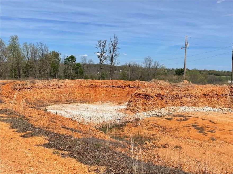 Positioned in a growing area just off Highway 412, this partially wooded property offers excellent accessibility while maintaining privacy, making it suitable for a variety of potential uses.
A standout feature of the property is the substantial red dirt pit, which presents opportunities for resource use, site development, or future land improvement projects. 
An existing 4-bedroom, 2-bath home is located on-site, offering potential for office use, rental income, or on-site living while developing or utilizing the land.
Conveniently located within:
~15 minutes to Siloam Springs
~20 minutes to Tontitown
Quick access to Highway 412
This is a rare chance to secure land with both immediate usability and long-term potential in a desirable Northwest Arkansas corridor.