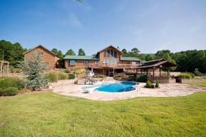 Fabulous Home with every luxury amenity, and amazing views from every part of this secluded property that backs up to the Ozark National Forest.Massive windows, vaulted ceilings and several fireplaces! The kitchen is every cooks dream, Custom cabinets offer a place for everything, Largeheated pool with an outdoor kitchen, and hot tub! Huge 40X60 heated and cooled shop! An an extra apartment over an oversized two car garage.Pond Outdoor covered area with a large fireplace and bathroom! This home has too many amenities to list!