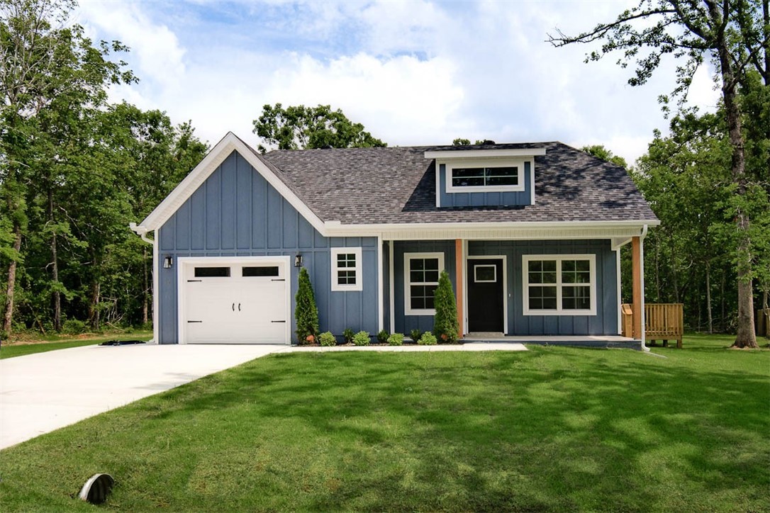 MOVE-IN READY! Discover this stunning new cons't craftsman style home located near Loch Lomond and provides easy access to Highlands Golf Course, Branchwood, & 1-49. This exquisite home sits on a FLAT .30 acre wooded lot and boasts high-end finishes throughout! Step inside to find a stylish open-concept layout, adorned with LVP floors. (no carpet) The focal point of the home is the kitchen, equipped with custom cabinets, a wood hood, luxurious countertops, and a large kitchen island. You'll love cooking with premium black stainless steel appliances, including a gas range. Retreat to the primary bath, where you'll find a spacious walk-in tile shower & double vanity. 2 bedrooms / 2 baths. Plus, take advantage of $3,500 in buyers closing costs, courtesy of the builder's preferred lender! This home is eligible for RD financing (no down payment).