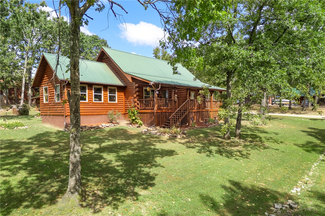 Welcome to this inviting 3-bedroom, 2-bath log cabin that blends rustic charm with everyday functionality. The warm wood finishes create a cozy atmosphere, while the spacious layout makes it easy to feel right at home. Outside, youāll find a detached garage that not only provides extra storage but also makes a great place to keep your boat or lake toys ready for your next adventure. A covered deck extends the living space outdoors, offering a comfortable spot to unwind and take in the surrounding beauty. Thoughtful landscaping enhances the propertyās curb appeal, giving it a well-kept and welcoming feel. Located near Bull Shoals Lake, this property features a seasonal lake view and easy access to outdoor recreation, making it an ideal choice for those who enjoy fishing, boating, or simply spending time in nature.