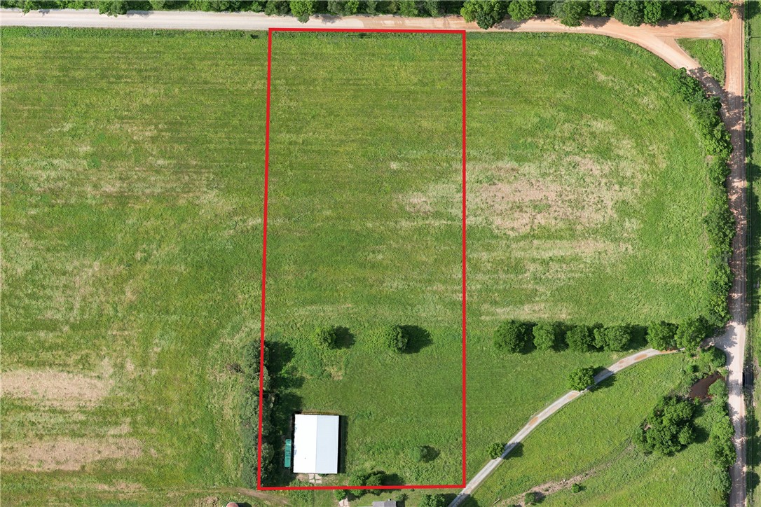 This peaceful and spacious 4 acre lot and comes with a ready-to-use 20,054 sq ft shop, making it perfect for anyone needing extra space for storage, hobbies, or a home-based business. The land is level and partially cleared, offering a versatile setting for a custom home, barndominium, or small farm setup. With road frontage and utilities nearby, this tract combines convenience with country living. Additional tracts also available for purchase. See MLS # 1309694 & 1309690.