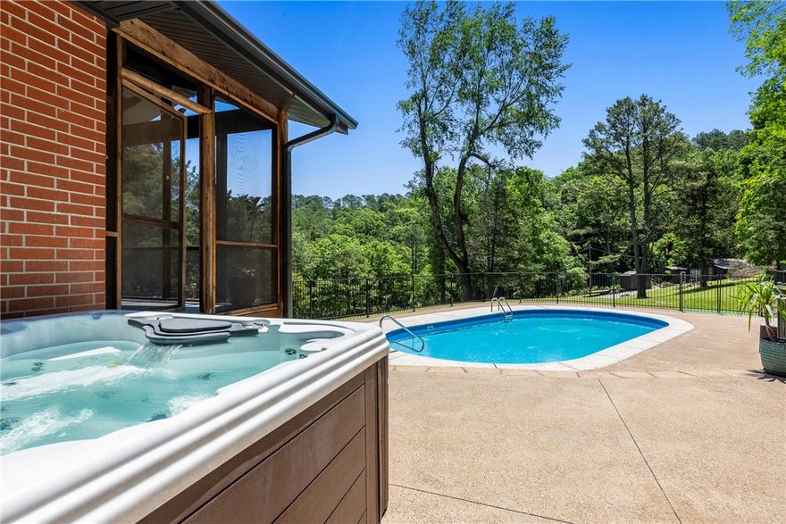 Live the life you've always dreamed of in this beautifully updated home near Beaver Lake & Hobbs State Park! Set on a serene .80-acre lot, this property offers privacy, space, & year-round enjoyment. Recent upgrades include: 30 year impact resistant fiberglass roof, high-end kitchen appliances, garage door, pool pump/filter, & engineered hardwood floors. Soak up the sun on the expansive concrete pool deck, take a dip in the heated pool, or unwind in the hot tub. A wraparound deck w/screened-in porch makes indoor-outdoor living effortless & irresistible. The fridge & hot tub convey, along w/a 10x14 shed for your active lifestyle. Winter brings breath taking lake views, while warmer months invite trail exploration & boating adventures just 5 min away at Rocky Branch Marina & the community boat launch. Whether you're entertaining guests or enjoying quiet mornings by the water, this home delivers the ultimate lifestyle in NWA. Cross listed with guest house in MLS1308963.
