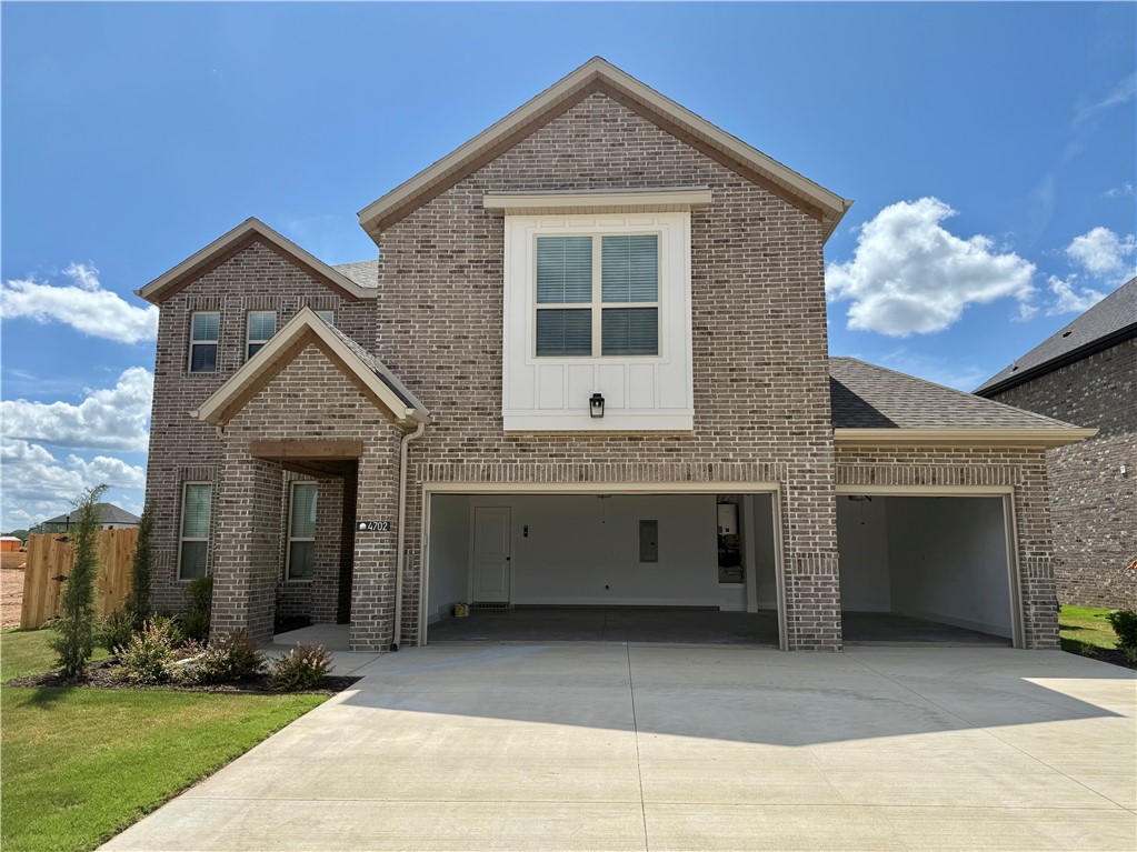 This thoughtfully designed home features open-concept living, abundant natural light, and an additional third-car garage. The exterior showcases stunning brickwork, while designer touches elevate the interior throughout. Enjoy quartz countertops, ceiling-height kitchen cabinets, an upgraded gas range, and a stacked oven/microwave combo—perfect for both everyday living and entertaining. Step outside to a covered back patio, ideal for relaxing evenings or morning coffee. Located less than 5 miles from XNA National Airport and just minutes from all that Bentonville and Centerton have to offer, this vibrant community combines small-town charm with exceptional convenience. Close to Walmart's New Home Office for those who are looking to relocate.