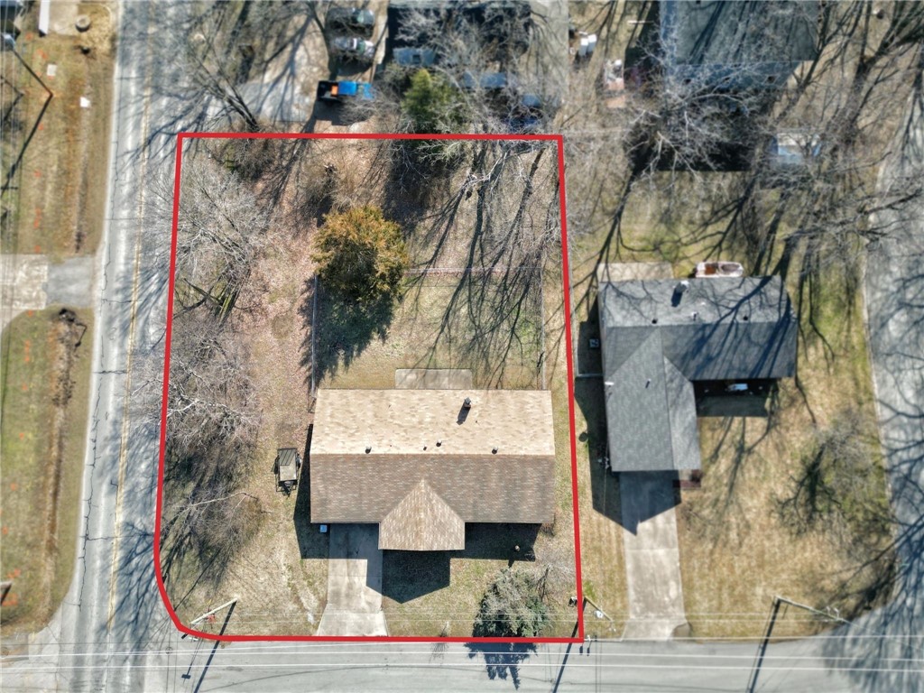 Commercial Lot in the development district located at SW A and 10th Street on a highly visible corner lot. This property is an opportunity to be a part of the Bentonville downtown core initiative. (.38) Acres that is currently zoned DC (Downtown Core). The intent of this zone is to maintain and expand the pedestrian-oriented character of the downtown square and extend those urban characteristics along the primary downtown street of SW A Street to Highway 102. Prime location as SW A street is a designated Primary Streets in the downtown district. Current home on oversized lot is in good condition and currently being lived in but not updated. Value of the property is in the lot/ location with over 151 ft of road frontage on SW A street and over 16,000 sq ft of potential for the right development. Listed in Residential MLS # 1238778.
