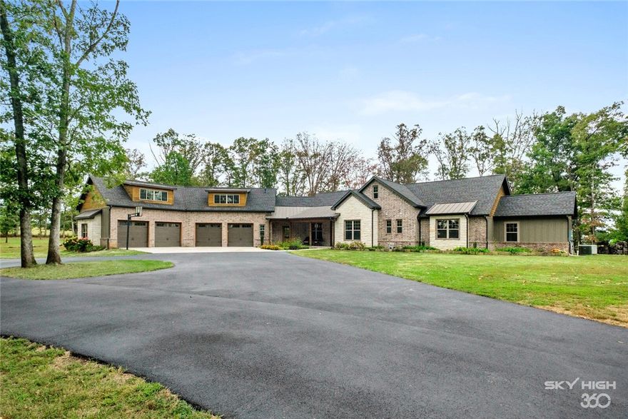 Stunning estate set on almost 6 acres of treelined countryside just minutes from XNA airport!  This beautiful 4 bedroom, 4.5 bath home is adorned with high quality finishes and an open floor plan perfect for entertaining.  The main level offers two spacious living areas, dining room,  owners retreat with 2 offices/exercise rooms, gourmet kitchen, soapstone countertops, ss appliances, pantry, double ovens and prep sink.  Custom details throughout the home include ship lapped walls, wood plank ceilings, beams, 3 fireplaces, mudroom with cubbies, desk, and a built in kennel for your pets. This home comes complete with 2 bonus rooms- one with almost 1,300 sq/ft and finished out with a full bathroom, kitchenette and ample space for many guests.  The estate also offers a saltwater pool, hot spring spa, whole house generator with dedicated propane tank, RV parking and a HUGE 4 bay 26 ft deep garage with 5- 9ft x8ft doors allowing you to park boats, tractors, SUV's and the biggest of trucks, all safely inside!