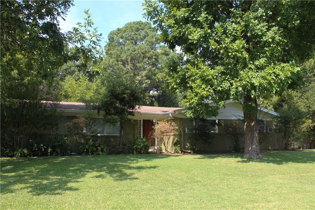 This move-in ready home is spotless from top to bottom! Offering 3 bedrooms, 2 full bathrooms, a spacious living room, a separate dining room, and a bright sunroom, it provides plenty of space for comfortable living. The kitchen has generous cabinet storage, and the double-car garage with keypad entry adds both convenience and security. Situated on a corner lot with lovely landscaping, the fenced backyard features a shaded sitting area, perfect for relaxing or entertaining. The HVAC system is only three years old, giving peace of mind for years to come. Located in a prime spot close to hospitals and less than 5 minutes from downtown Russellville, this home truly has it all. Schedule your showing today, this one wonāt last!