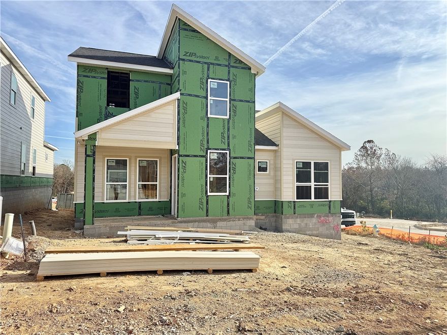 Discover this stunning modern home in the perfect East Fayetteville location—just a short walk to beloved Gulley Park! Ewan floorplan featuring designer finishes throughout! Enjoy a spacious open floorplan with a large living room, electric fireplace with accent wall, and beautiful wood flooring. The chef’s kitchen boasts 3cm quartz countertops, stainless steel frigidaire professional-grade appliances, custom cabinets to the ceiling with soft close hinges, vented hood, and a walk-in pantry. The luxurious primary suite includes hardwood floors, custom beams, and a spa-like bathroom with walk in tile shower, soaking tub, double sinks and walk in closet. With a formal dining area with accent wall, lot upstairs for relaxing, cubbies to keep you organized, large covered patio, and included blinds and gutters, this home blends comfort, style, and convenience in one unbeatable package. POA maintained lawncare!