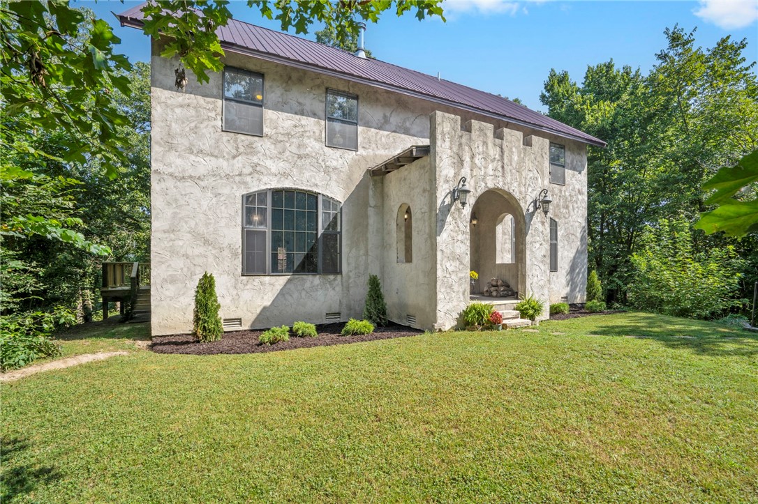 This one of a kind estate known as "Castle Gate" was designed & built by the Willis Family (Architect/ Prof. Willis- Head of the Dep. of Building Cons. at JBU). Sitting proudly at over 1100 ft overlooking 2.74 acres of wooded forest, this home offers complete privacy and serenity. The handcrafted 8āx5ā oak front door w/ wrought-iron straps opens to the "Great Hall" living area w/ 14ā tall ceilings, Italian-style open beams and cast slats & a large formal dining room. The custom kitchen features a stone archway framing the downdraft Jenn Air range, a hand planed butcher block island, 1.25" granite countertops, and a breakfast nook. The second level boasts of a large "Master Suite" spanning full width of the house, entered via double French doors, plus 2 large bedrooms and an additional full bath. The third floor has an additional living room, 2 large bedrooms and 1 bath. The finished basement offers an additional 500+ sq. ft. The 2 story, detached workshop offers an additional 1232 Sq. Ft. of storage/ workspace.