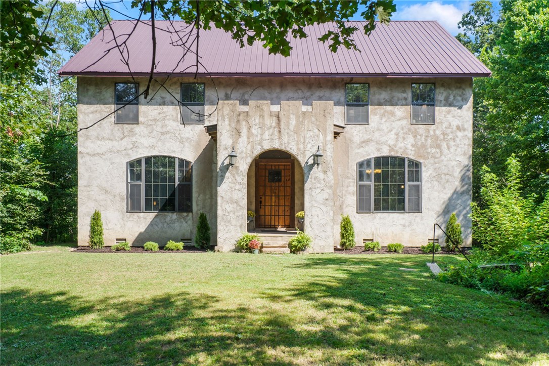This one of a kind estate, known as "Castle Gate" sits proudly at over 1100 ft overlooking 2.74 acres of wooded forest. This home and property offers complete privacy and serenity. Enjoy being completely surrounded by nature, and just minutes from town. The handcrafted 8āx5ā oak front door w/ wrought-iron straps opens to the "Great Hall" living area w/ 14ā tall ceilings, Italian-style open beams and cast slats & a large formal dining room. The custom kitchen features a stone archway framing the downdraft Jenn Air range, a hand planed butcher block island, 1.25" granite countertops, and a breakfast nook. The second level boasts of a large "Master Suite" spanning full width of the house, entered via double French doors, plus 2 large bedrooms and an additional full bath. The third floor has an additional living room, 2 large bedrooms and 1 bath. The finished basement offers an additional 500+ sq. ft. The 2 story, detached workshop offers an additional 1232 Sq. Ft. of storage/ workspace.