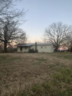 COUNTRY SETTING CALLING YOUR NAME!! This 3 bedroom home is just waiting on your vision! With hardwood floors, 7.34 acres, good timber, anda well! it's just waiting on you to call and make it your own!! Survey coming soon.