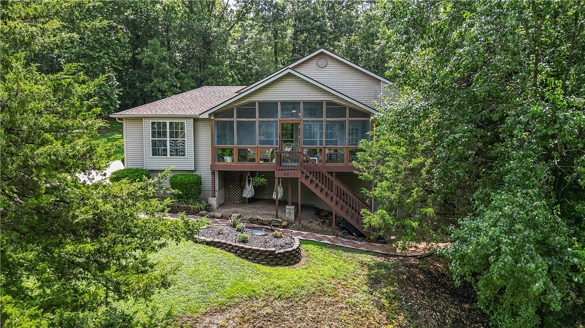 Enjoy Lake Windsor views from the comfort of your front screened-in porch! This beautiful Bella Vista home offers serene lake living with a peaceful waterfall and koi pond right off your expansive composite back deckāperfect for relaxing or entertaining. The home features an open-concept living room and kitchen with a gorgeous marble fireplace, creating a bright and inviting space as you walk in. The spacious master suite includes a large bathroom, walk-in closet, and direct access to the screened-in porch with lake views.Downstairs, youāll find an additional versatile room with a half bath and private deckāideal for a guest suite, home office, or potential Airbnb. Enjoy multiple wraparound decks providing outdoor living spaces all around the home. Located in the Bentonville School District with quick access to Highway 49, this property also conveys with an additional 0.23-acre lot, creating a large side yard with endless possibilities. Donāt miss this rare opportunityāschedule your showing today!