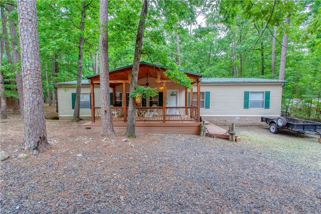 Spacious Open-Concept Mobile Home in Mountain Harbor Resort! Discover your perfect family retreat in this spacious open-concept mobile home located in the highly sought-after Mountain Harbor Resort. Featuring 3 comfortable bedrooms, a beautiful front deck and a screened back porch, this home is ideal for relaxing after a day at the Lake. Enjoy the natural beauty and recreational opportunities of Lake Ouachita while making unforgettable memories with loved ones. Whether you are seeking a weekend getaway or a seasonal escape, this home offers the charm, comfort and location you've been dreaming of.